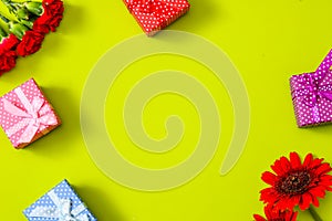 Carnations,transvaal daisy and gift box in a pink background