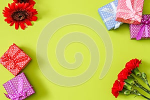 Carnations,transvaal daisy and gift box in a pink background