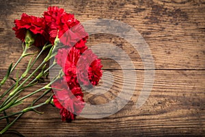 Carnations on wooden background