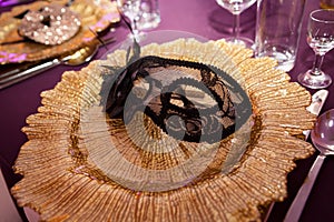 Carnaval table with venetian mask on the plate