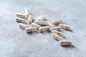 Carnitine capsules. Concept for a healthy dietary supplementation. Bright stone background.