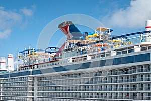 Carnival Celebration Cruise ship with roller coaster and water park docked in San Juan.