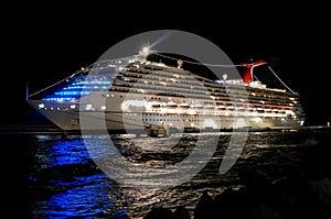 Carnival Conquest cruise ship illuminated at night by the St Anna Bay near Willemstad, Curacao