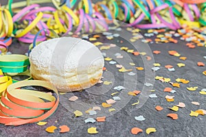 Carnival Donut with carnival decoration on a slate