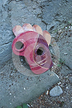 Carnival in Italy. Abandoned ceramic mask on the street