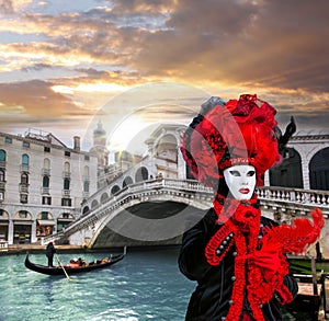 Carnival mask against Rialto bridge in Venice, Italy