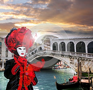 Carnival mask against Rialto bridge in Venice, Italy