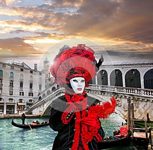 Carnival mask against Rialto bridge in Venice, Italy