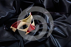 Carnival mask isolated on black satin background