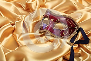 Carnival mask isolated on golden satin background