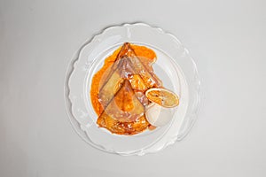 Carnival menu. Top view of delicious pancakes with orange sauce and vanilla ice cream on a white background