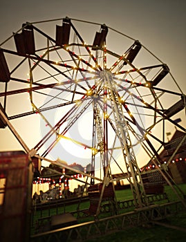 Carnival midway background with Ferris wheel and carousel . photo