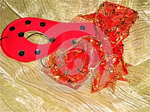 Carnival red mask and bow with spangles.