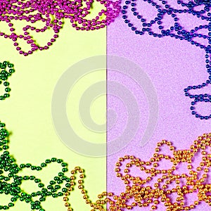 Carnival shiny beads, traditional carnaval accessories. Mardi gras frame or border on purple background, masquerade masks and