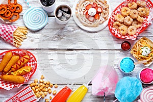 Carnival theme food frame over a white wood background