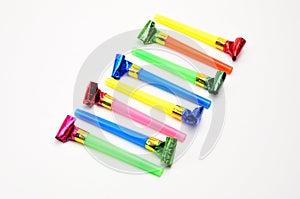 Carnival whistles of different colors on a white background