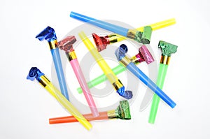 Carnival whistles of different colors on a white background