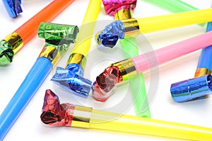 Carnival whistles of different colors on a white background