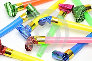 Carnival whistles of different colors on a white background