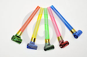 Carnival whistles of different colors on a white background
