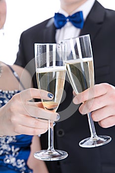 Carnival: young couple isolated on white drinking champagne