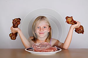 Carnivore keto diet concept - little blond girl eating raw meat