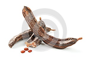 Carob carob fruit and seeds on white background. Isolate. Organic carob beans, a healthy alternative to cocoa