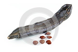 Carob pod or St. John's bread with seeds, isolated on white