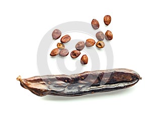 Carob pods with seeds on white background