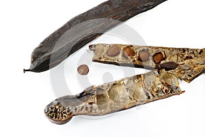Carob pods / St. John's bread with seeds, close up, isolated on