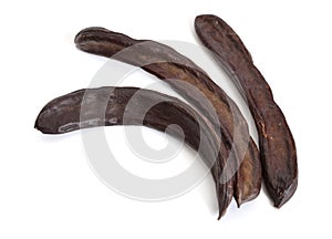 Carob pods on white background