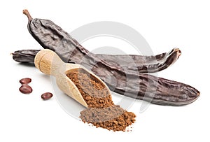 Carob powder and pods isolated on white