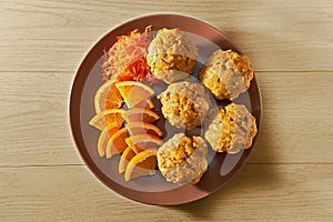 Carotte muffins served on the plate with orange slices photo