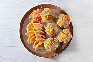 Carotte muffins served on the plate with orange slices photo