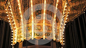 Carousel in an amusement park in slow motion at night. Holiday entertainment in the amusement park