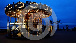 Carousel on the beach in the rain