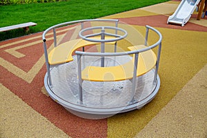 A carousel on a beautiful rubberized surface in the form of triangles on the playground in kindergarten