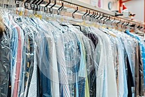 Carousel of clothing waiting for pick-up in dry cleaning shop