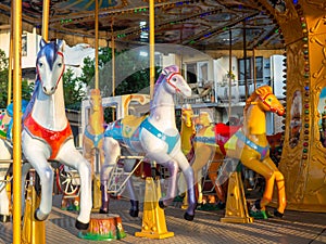 Carousel with horses. Bright attraction for children. Entertainment in the park.