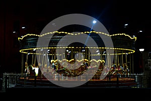 carousel with several lights on top of it at night time