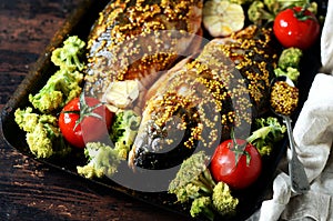 Carp before baking with vegetables: broccoli, tomatoes