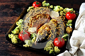 Carp before baking with vegetables: broccoli, tomatoes