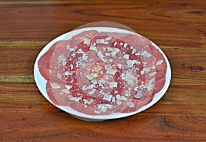 Carpaccio beef dish with Parmesan cheese photo