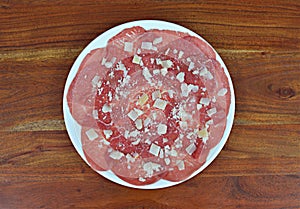 Carpaccio beef dish with Parmesan cheese photo