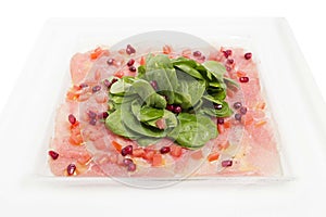 Carpaccio meat with shpinach in a white plate