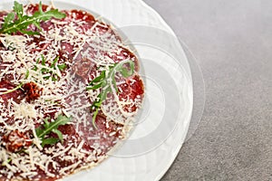 Carpaccio on white plate. Copyspace for text.