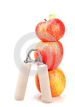 Carpal expander and a stack of three red apples