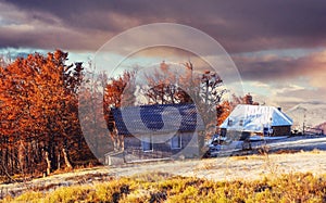 Carpathian mountain landscape with wooden farmhouse. October mou