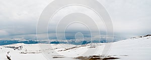 Carpathian mountains covered in snow and heavy clouds panoramic