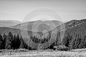 Carpathian mountains in summer and an old wooden house